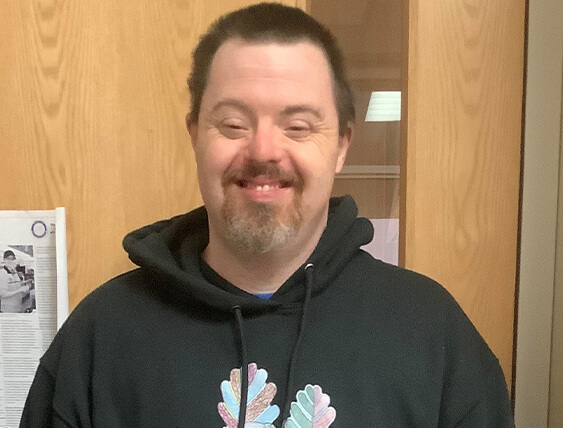 smiling man in sweatshirt
